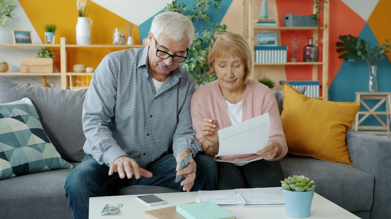 Older couple reviewing paperwork together at home