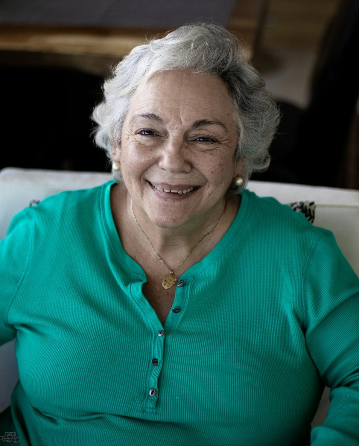 Smiling older woman in a teal top