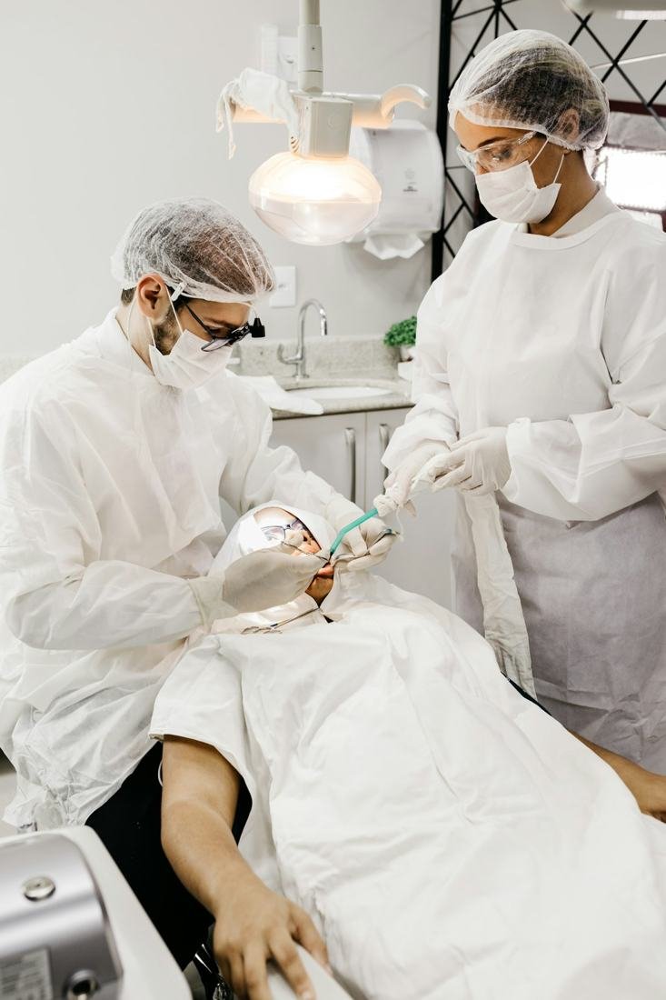 Dental team caring for a patient in the treatment room